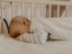 a baby sleeping in a crib